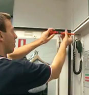 Man installing fire monitoring panel